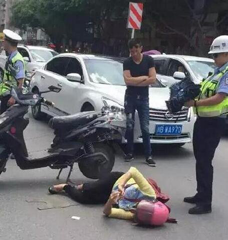 一女子躺马路边玩微信，身边还有交警“保护”？